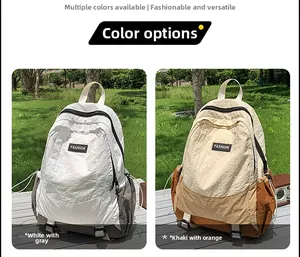 Outdoor leisure backpacks in white-grey and khaki-orange shown on park grass
