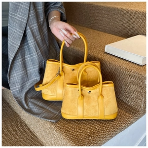 Detailed comparison of two mango yellow suede tote bags in medium and small sizes