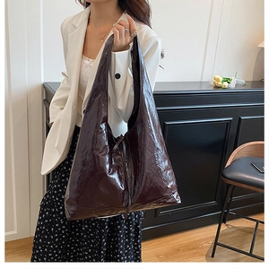 Deep burgundy glossy patent leather hobo bag side view with delicate lace details