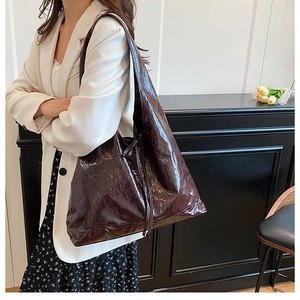 Brown vintage oil-wax leather tote bag worn by a model in a professional office setting