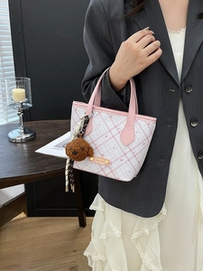 Chic pink checkered bucket bag for women with a cute teddy bear charm and metal plate