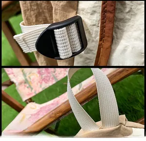 Detail view of the durable plastic buckle and reinforced handle on the beige crossbody bag