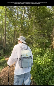 Outdoor forest scene showing detailed stitching and patchwork of the nylon backpack