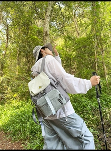 Detail of waterproof nylon hiking backpack with adjustable straps in forest setting