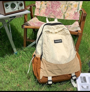 Outdoor leisure backpack detail showing fashion label, zipper design and buckle strap