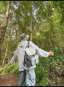 Outdoor waterproof nylon backpack in grey and mint green with smiley face flap detail