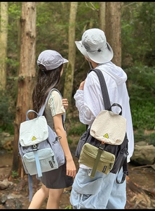 Detailed outdoor view of a lightweight nylon backpack with a stylish stitched brand label