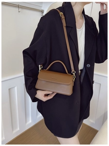 Detail of vintage brown rectangular shoulder bag with MILANKOU logo and gold hardware