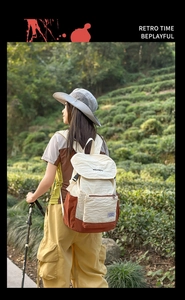 Detail of outdoor hiking backpack with color-blocking design against a lush tea garden