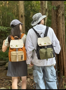 Outdoor leisure backpacks in orange and green shown in a natural forest setting