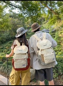 Outdoor backpacks in color-block canvas nylon shown in a scenic mountain background