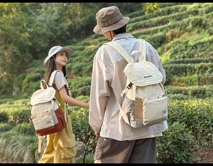 Outdoor canvas backpack featuring off-white wrinkled texture and colorful block stitching