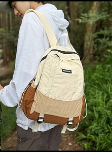 Detail of color-block nylon outdoor backpack featuring a textured finish and fashion label