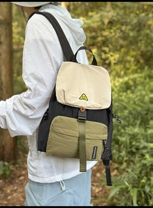 Detail of water-resistant nylon backpack with multicolor patchwork and adjustable straps