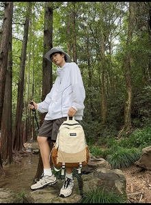 Outdoor hiking backpack detail with beige and brown contrast colors and double zippers