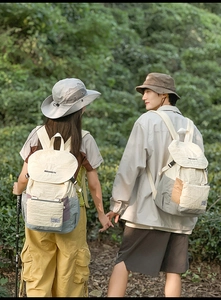 Outdoor backpacks in contrast colors shown in a forest setting for hiking and travel