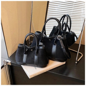 Size comparison of two black matte tote bags in a stylish interior setting with shadow effects