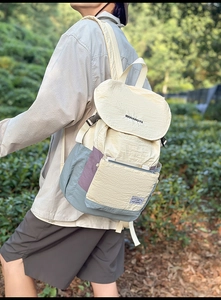 Detail of multi-pocket canvas backpack with crinkle texture and buckles for outdoor travel