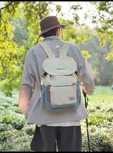 Outdoor backpack detail showing water-repellent fabric texture and color-block design