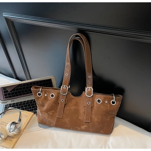Detail of vintage brown tote bag with metal eyelets and large capacity for a laptop