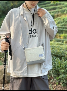 Close-up of lightweight nylon travel backpack with wrinkled texture and mountain carabiner