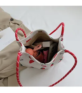 Top view of strawberry tote bag showing spacious interior with phone and umbrella