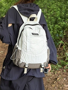 Outdoor lightweight nylon backpack in white and grey with buckles for hiking and commuting
