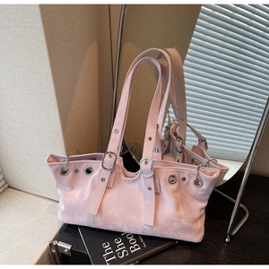 Detailed macro view of light pink tote bag with metal eyelets and matte texture finish