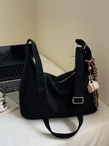 Minimalist black corduroy tote bag with coffee charm and adjustable strap for daily use