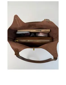 Top view of brown leather bucket bag with inner pouch showing large storage capacity