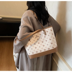 Detail of deer pattern tote bag with leather straps and large interior capacity