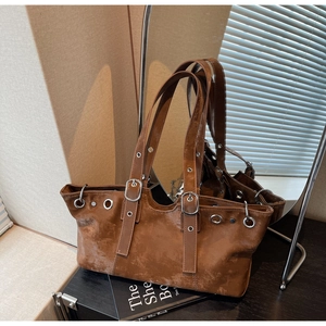 Detailed macro view of vintage caramel brown tote bag with metal eyelets and rivets