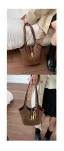 Brown vintage bucket bag with litchi texture and gold buckle shown in casual style