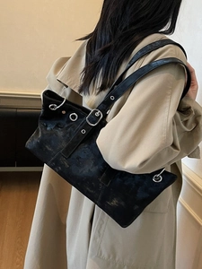 Retro black leather underarm tote bag with metallic eyelets and adjustable straps