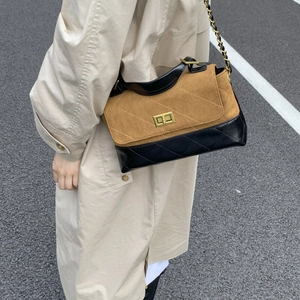 Close-up of vintage chain strap and quilted leather texture on a crossbody bag