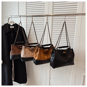 Detail view of large quilted tote bags in dark brown beige camel and black colors