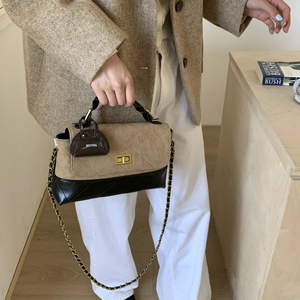 Quilted crossbody bag with gold turn-lock, chain strap, and mini charm detail