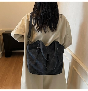 Detailed back view of a dark grey tote bag with adjustable shoulder strap and metal buckle