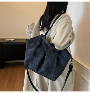 Detail of vintage matte shoulder bag with adjustable strap and refined suede texture