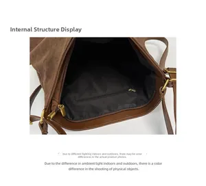 Detail view of the deep brown suede bucket bag featuring black lining and gold zipper pocket