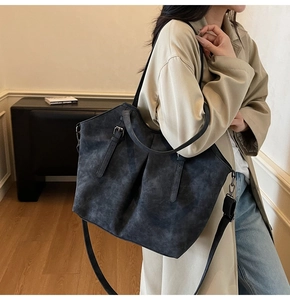 Detail of vintage grey tote bag with washed matte texture and adjustable shoulder strap