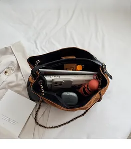 Top view of spacious brown suede tote bag showing interior storage for umbrella and books