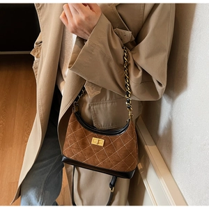 Brown suede hobo bag with white diamond stitching and sleek black leather trim details