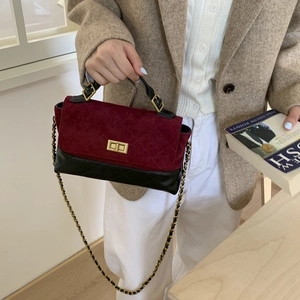 Detail of retro quilted crossbody bag in burgundy suede and black leather with gold chain