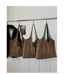 Detailed view of leopard print tote bags showing three different interior lining colors