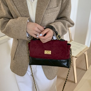 Detail view of the vintage crossbody bag with wine red suede and black quilted leather