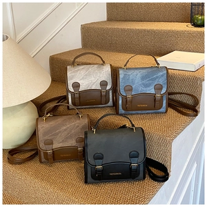 Detail showing vintage flap crossbody bags in four colors on a textured staircase