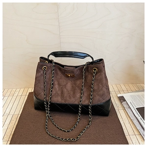 Detail showing vintage brown suede and black quilted leather with retro copper buckle closure
