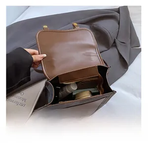 Internal view of brown leather backpack showing spacious compartments and zip pocket