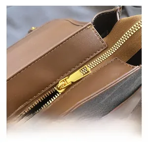 Close-up of golden metal zipper hardware on brown vintage leather backpack